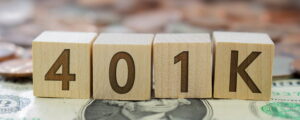 Person reviewing finances and considering using 401(k) savings to pay off debt