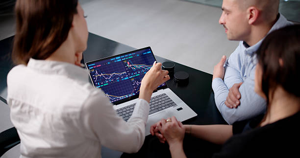 Advisor reviewing investment performance with a couple at a conference table